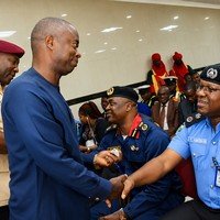 Civilian and police officer shaking hands